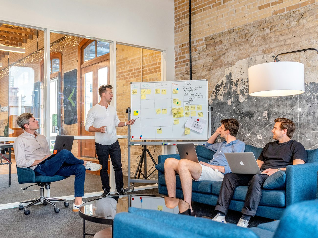 A team collaborating around a whiteboard in a warm office