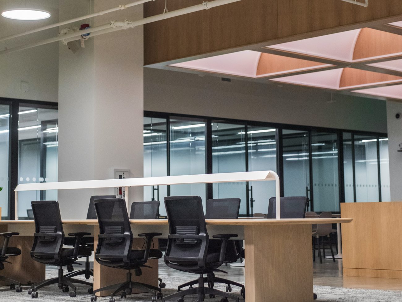 A calm, modern office workspace with desks and chairs